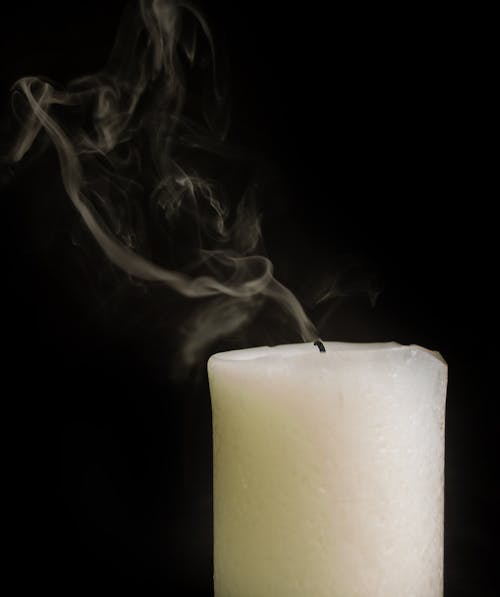 Free Extinguished thick wax candle with smoke Stock Photo