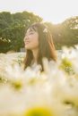 Woman Eyes Closed in the Middle of Flower Garden