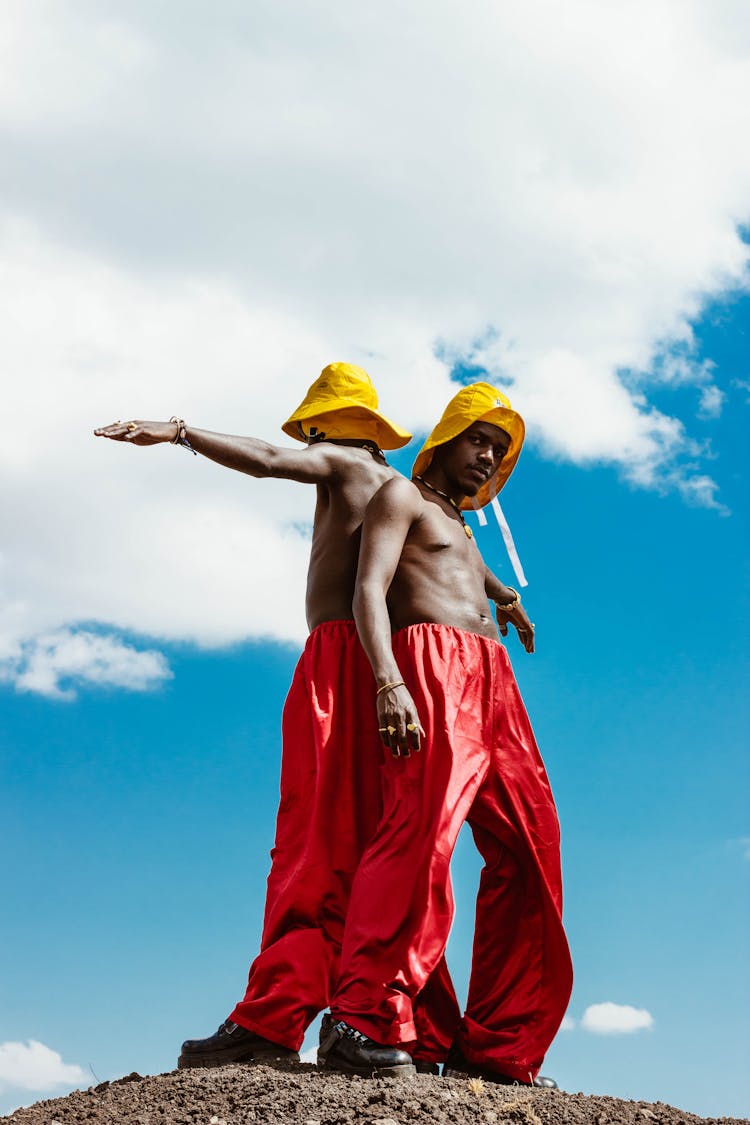 Men Wearing Yellow Hats And Red Pants