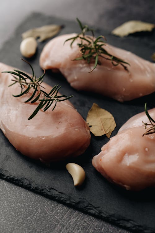 Free Uncooked Chicken Breast with Rosemary Stock Photo