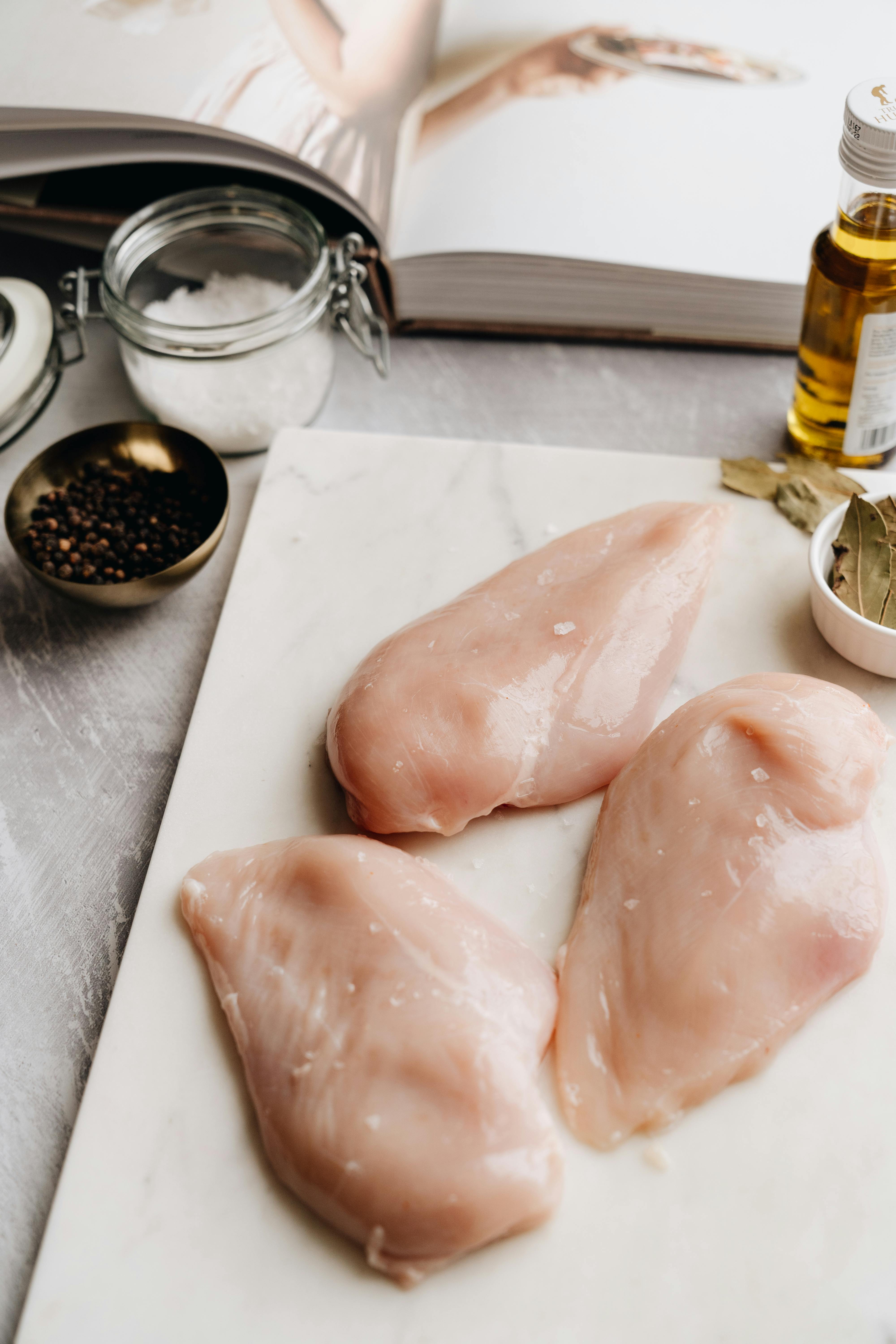 Raw Chicken Breast On A Wooden Cutting Board Stock Photo, Picture and  Royalty Free Image. Image 27433651.