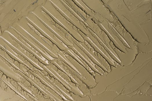 Close-up of a beige textured abstract artwork showcasing layered patterns.