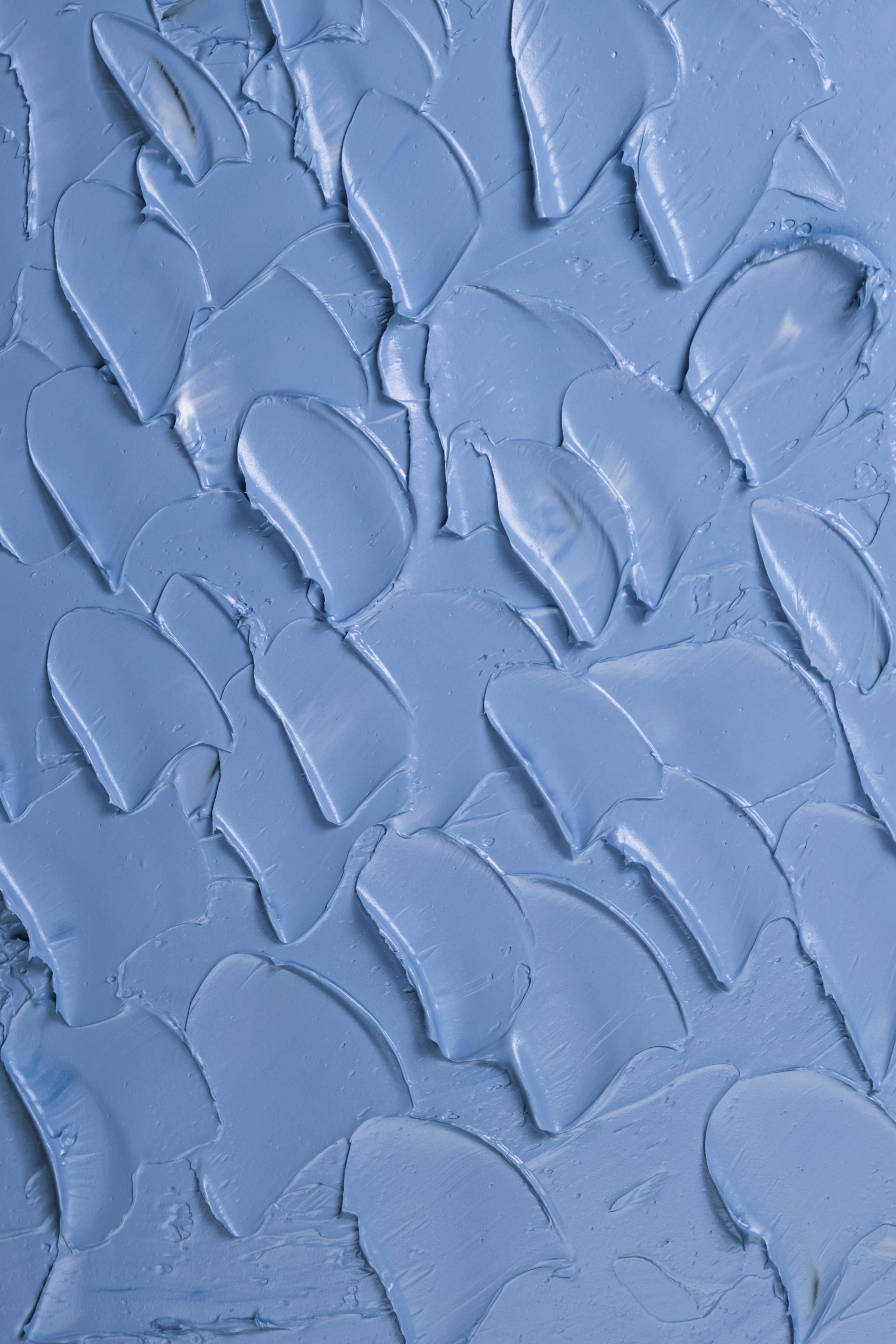 Close-up of blue textured paint creating an abstract art pattern with a modern aesthetic.