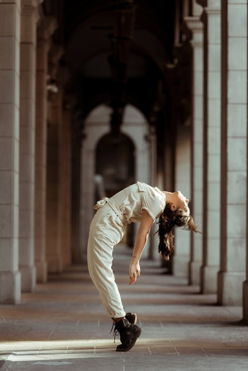 Free Young woman dancing and leaning back Stock Photo