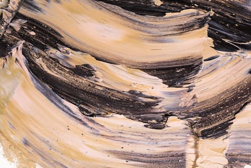 Close-Up Photo of Multicolored Smudges of Oil Paint on Canvas