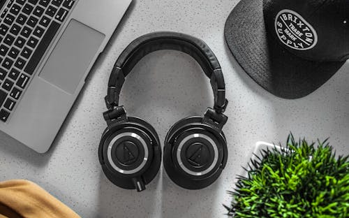 Free Black Wireless Headphones On White Table Stock Photo