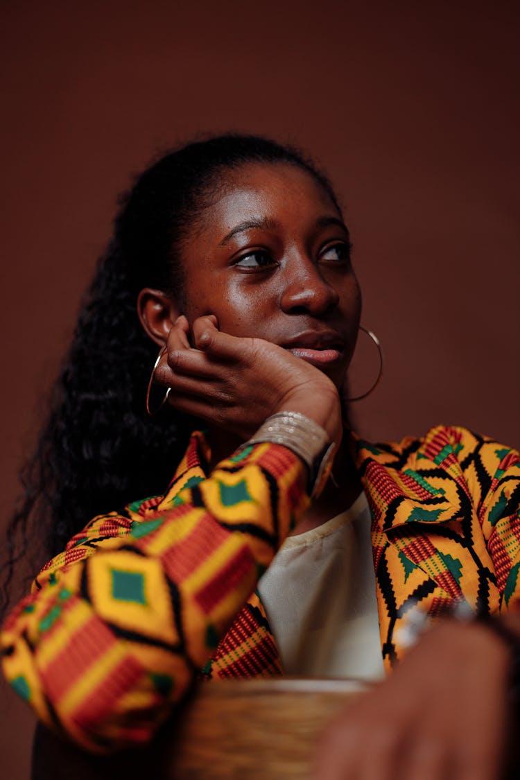 A Woman Posing With Her Hand On Cheek