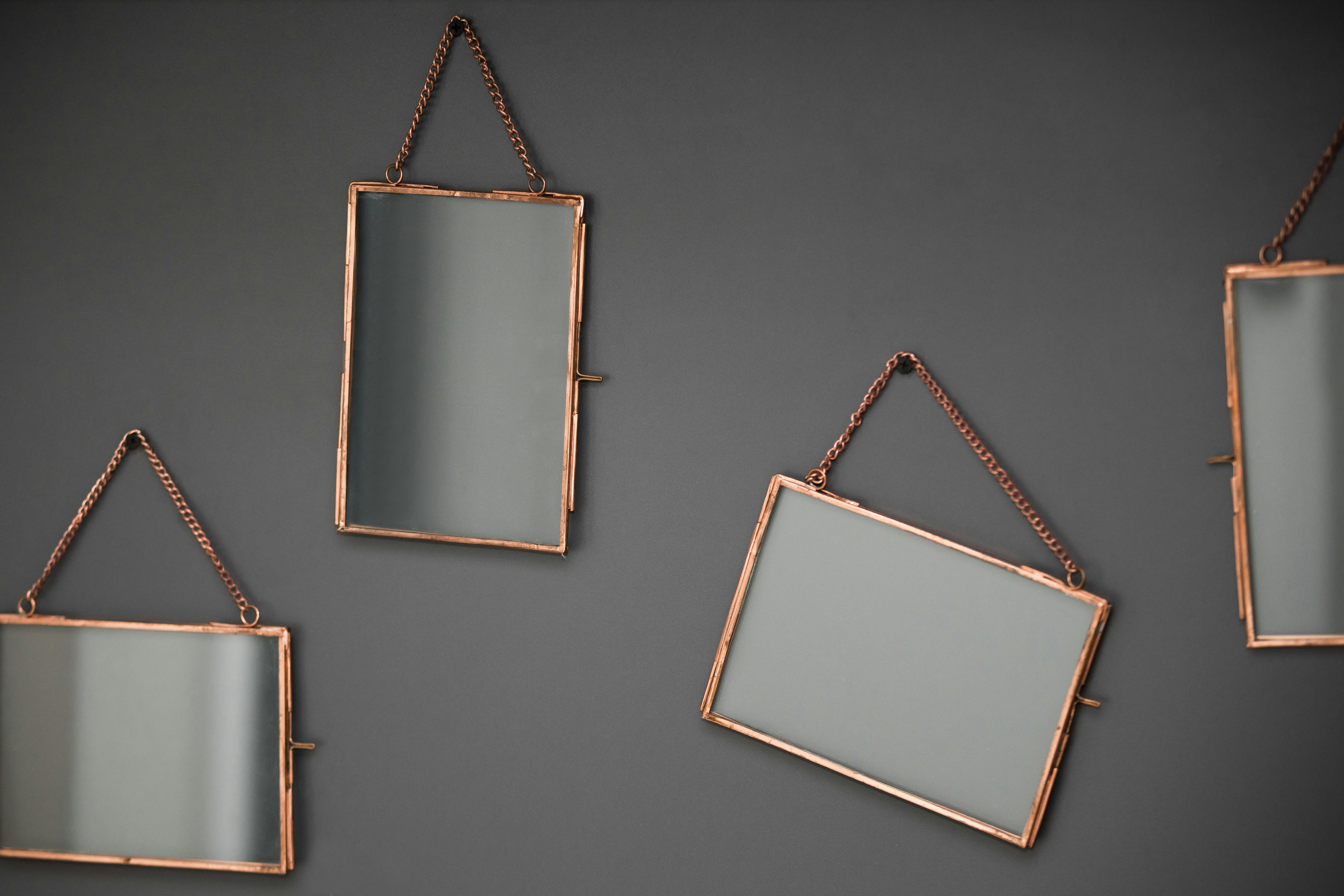 Framed mirrors hanging on wall · Free Stock Photo