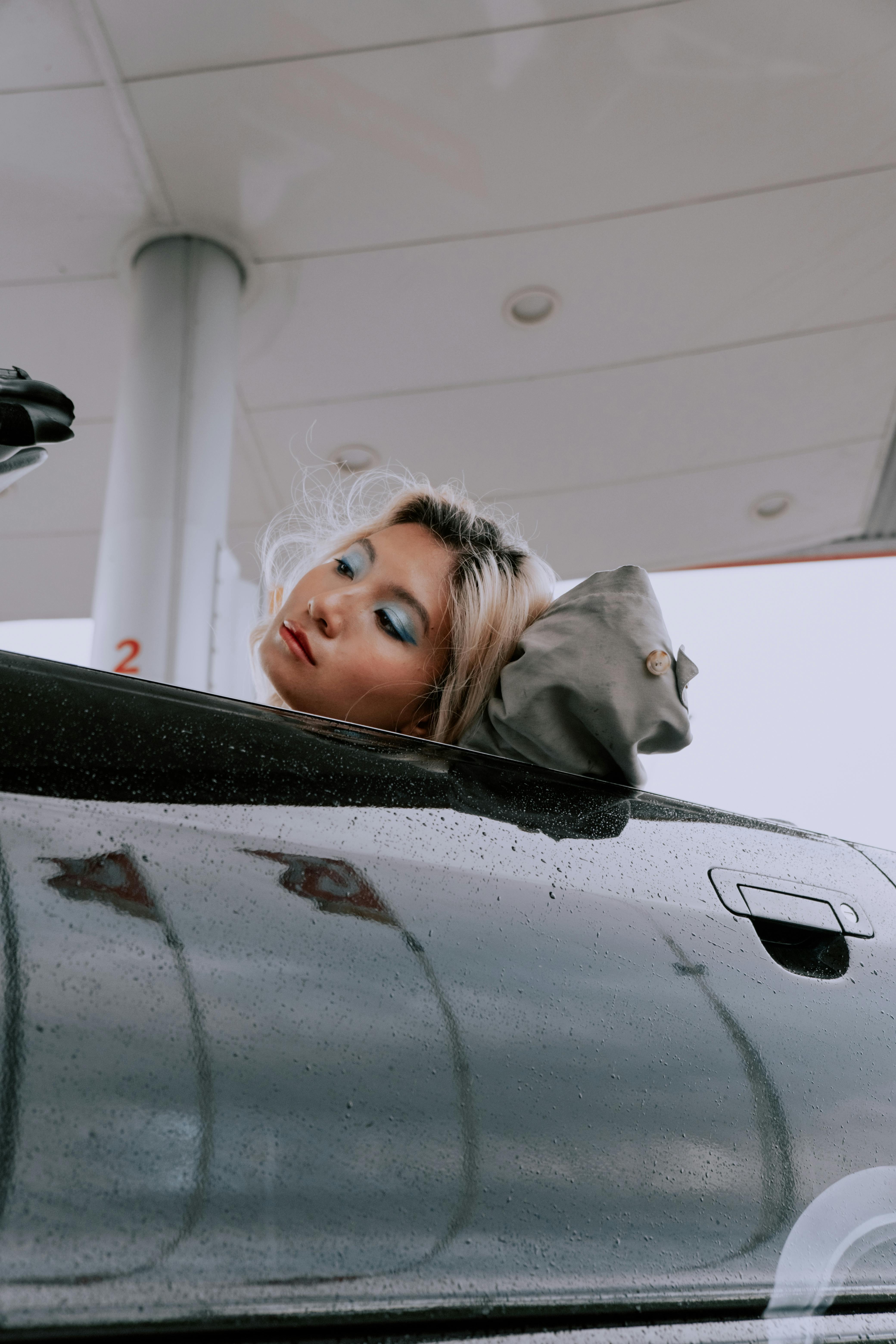 Girl in Gray Hoodie Leaning on Gray Car · Free Stock Photo