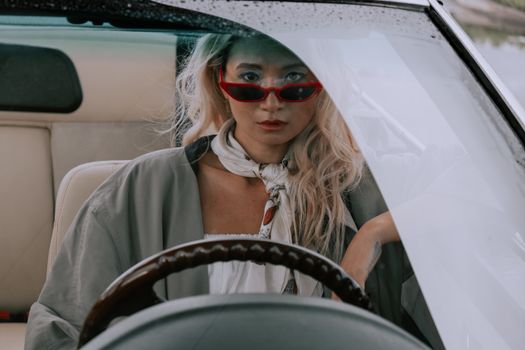 A Woman Wearing Sunglasses Sitting in the Car 