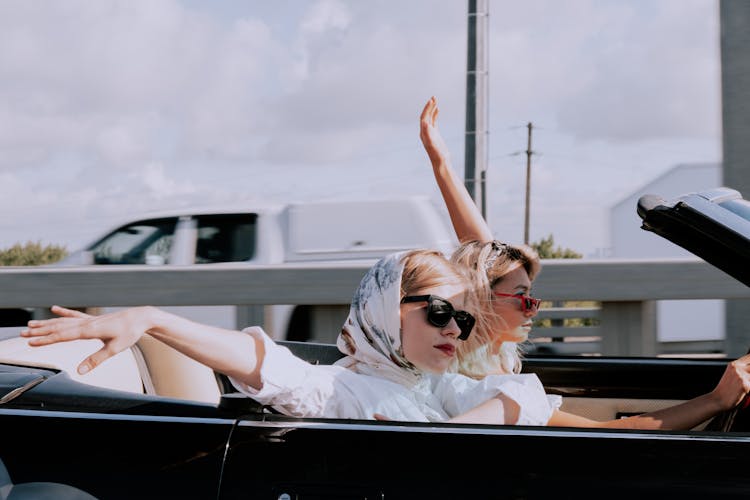 Women Wearing A Headscarf In A Convertible Car