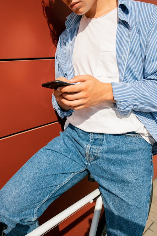 A Person Browsing a Smartphone While Sitting on a Bike