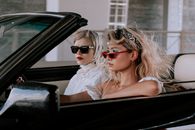 Stylish Friends Traveling on a Cabriolet