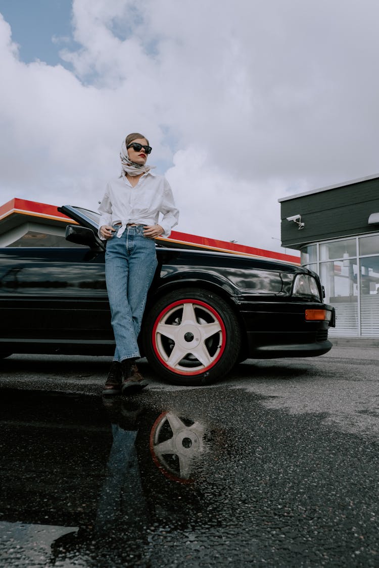 Stylish Woman Leaning On A Car
