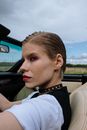 Woman in White Shirt Driving Car