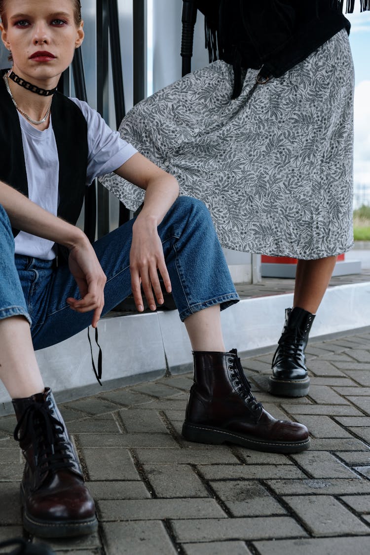 Woman In Denim Jeans Wearing A Black Leather Boots