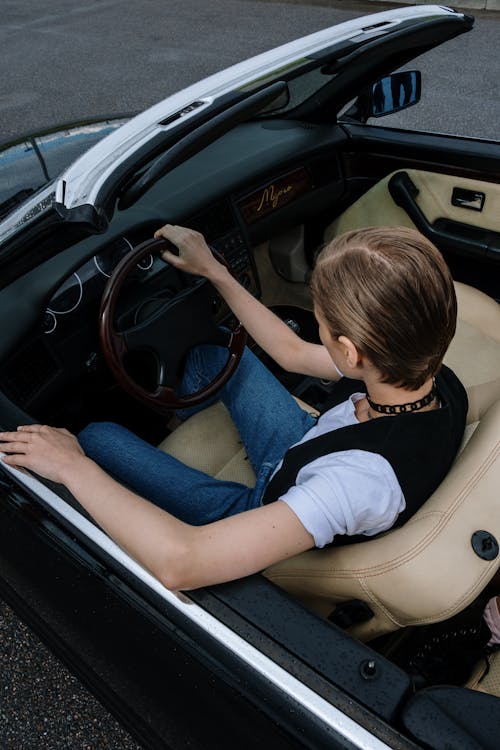 Free Woman in White T-shirt Driving Car Stock Photo