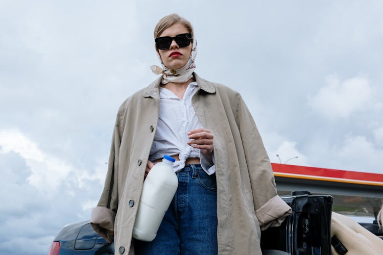 A Woman Wearing Sunglasses And Brown Coat