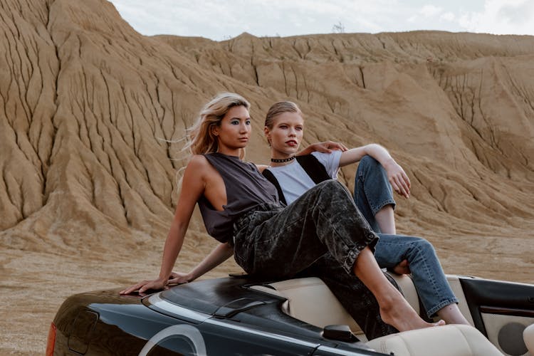 Two Women Sitting On The Top Down Vehicle