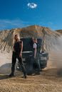 Man in Black T-shirt Standing Beside Black Car