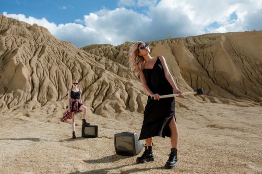 Woman in Black Tank Top and Black Shorts Holding White and Black Luggage Bag