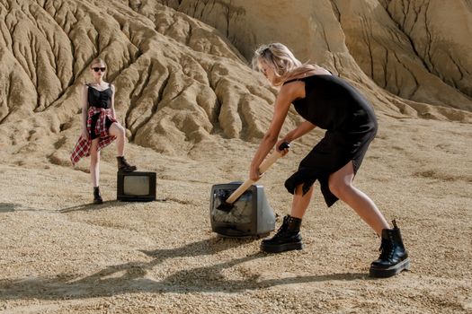 Man in Black T-shirt and Red Shorts Holding Black and Gray Shovel