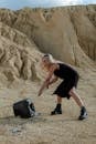 Woman in Black Tank Top and Black Shorts Carrying Black Leather Handbag