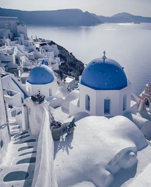 Free Blue Domed Church and Houses in Santorini Stock Photo