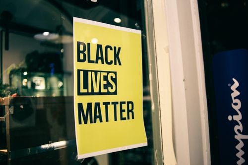 Free Colorful yellow rectangular shaped signboard with inscription Black Lives Matter on glass door Stock Photo