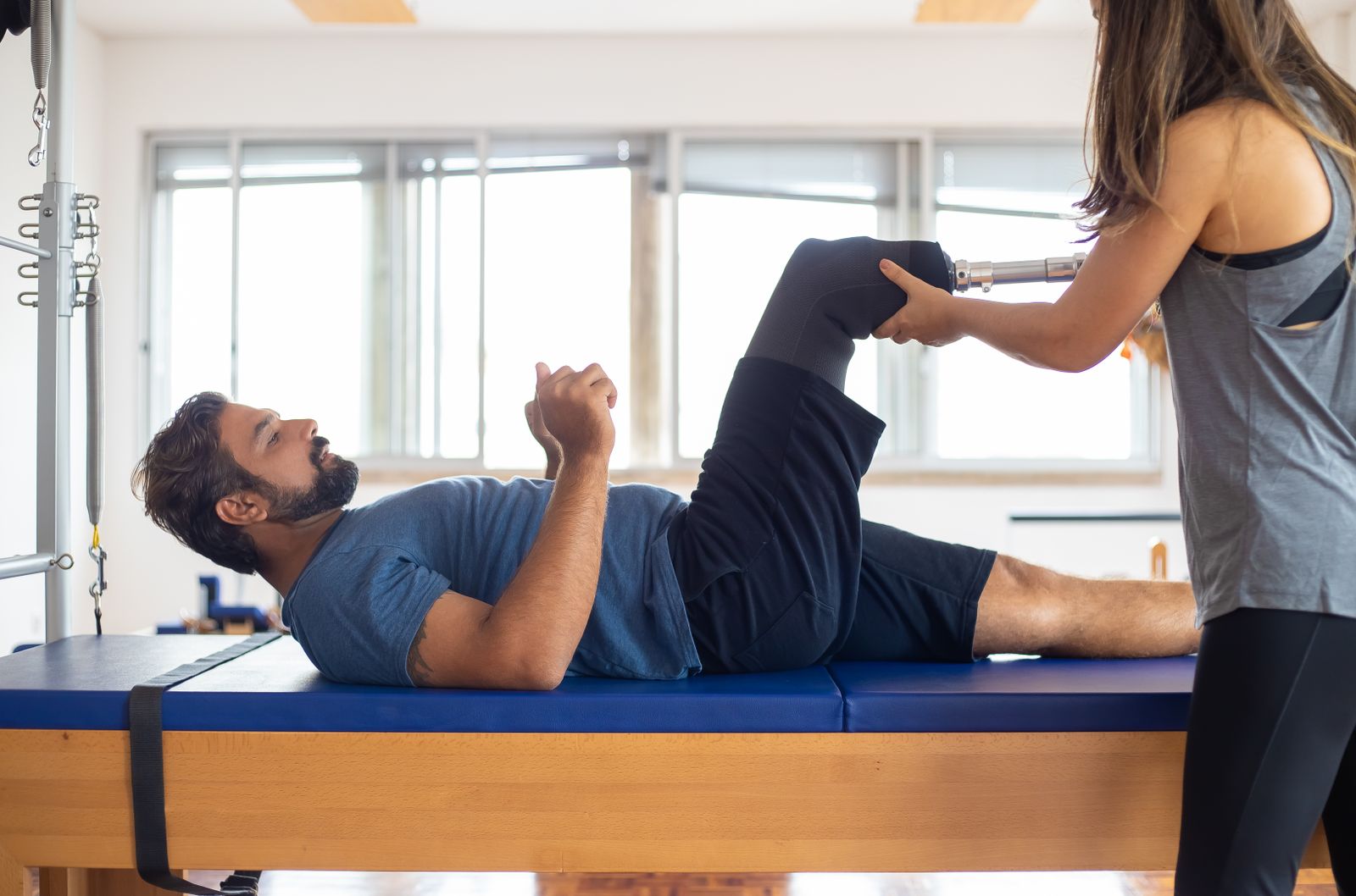 Person stretching outdoors with hands near the lower back and pelvis