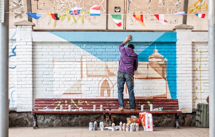 Street Artist Painting A Mural