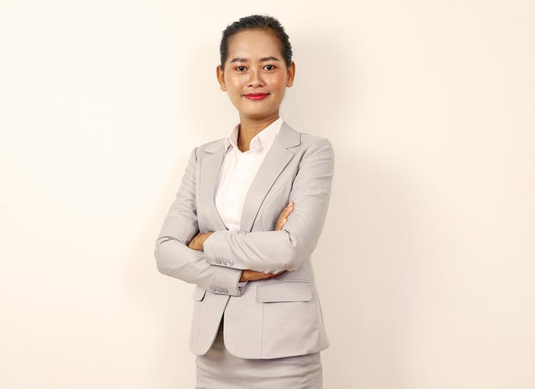 A Standing Woman In Business Attire 