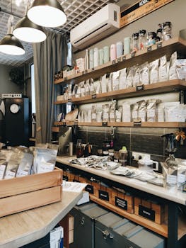 Charming coffee shop interior in Novosibirsk showcasing shelves of packaged products and coffee accessories.