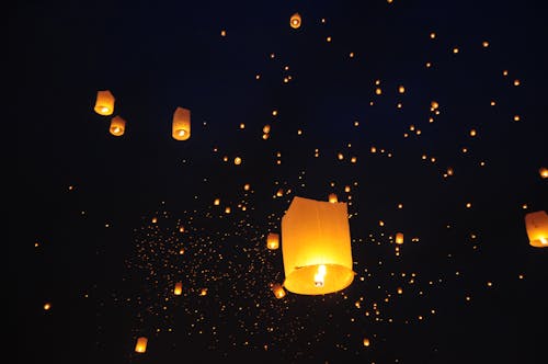 Free Paper Lantern with Candles Floating in the Air Stock Photo