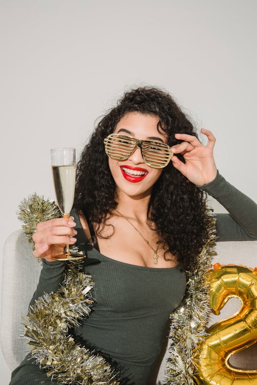 Cheerful woman with champagne glass celebrating new year