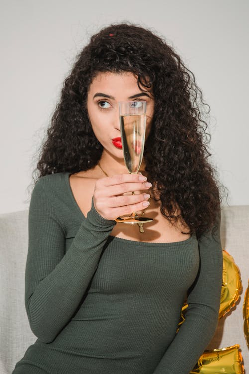 Woman with curly hair and glass of champagne