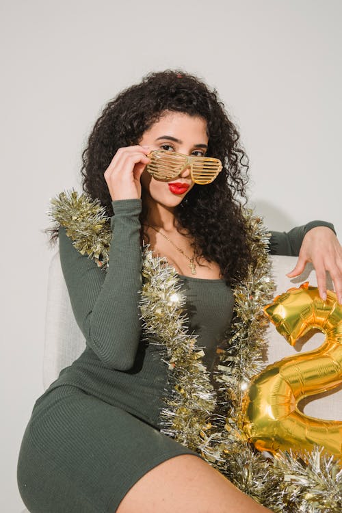 Woman in striped glasses and shimmering tinsel
