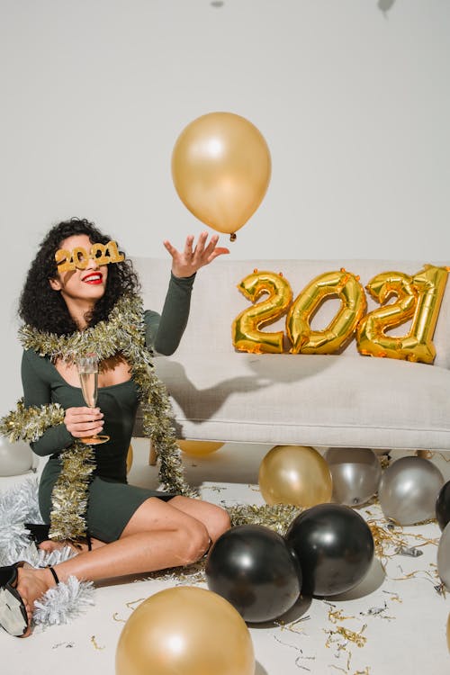 A Woman Celebrating 2021 with Balloons