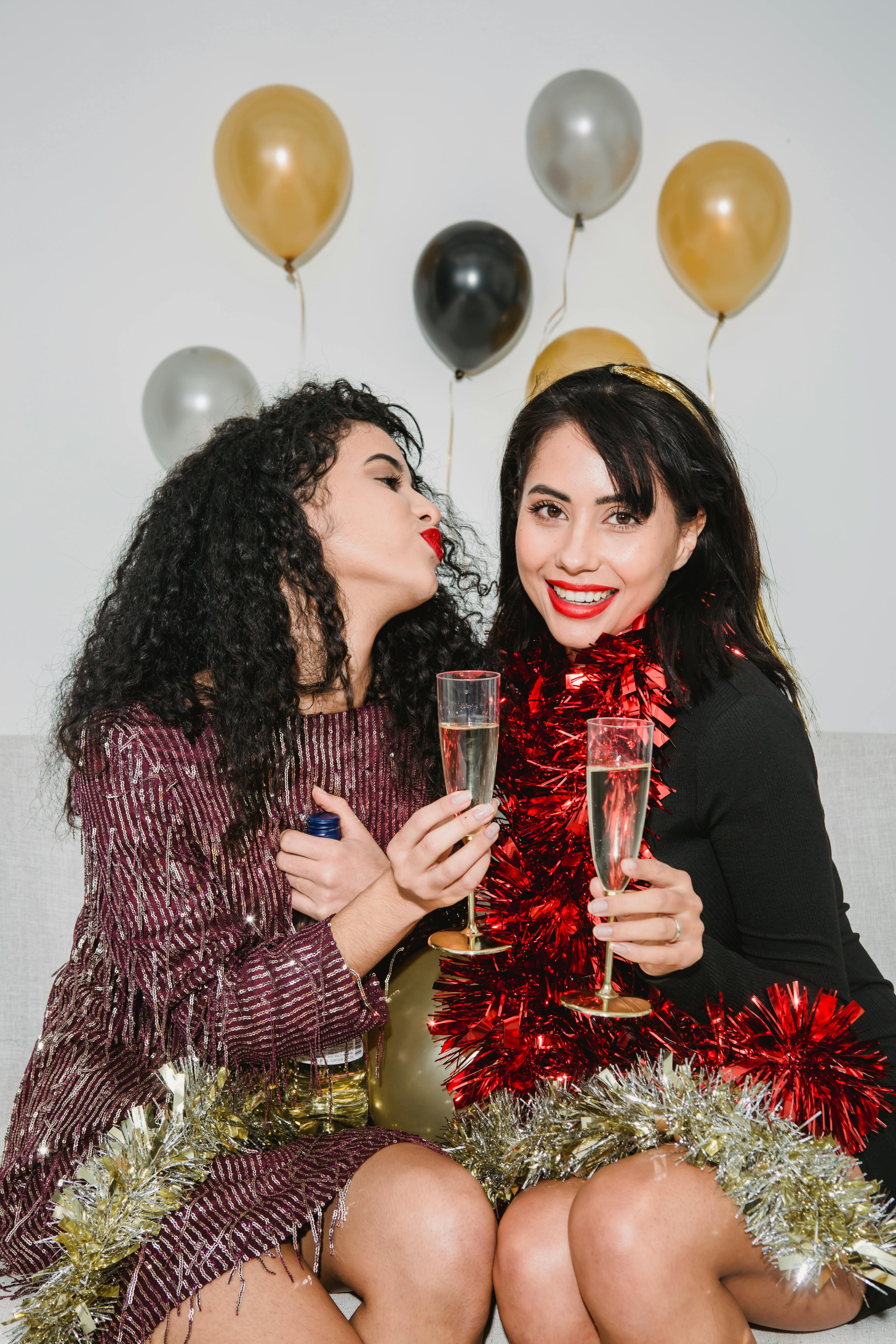 cheerful women celebrating new year while drinking champagne