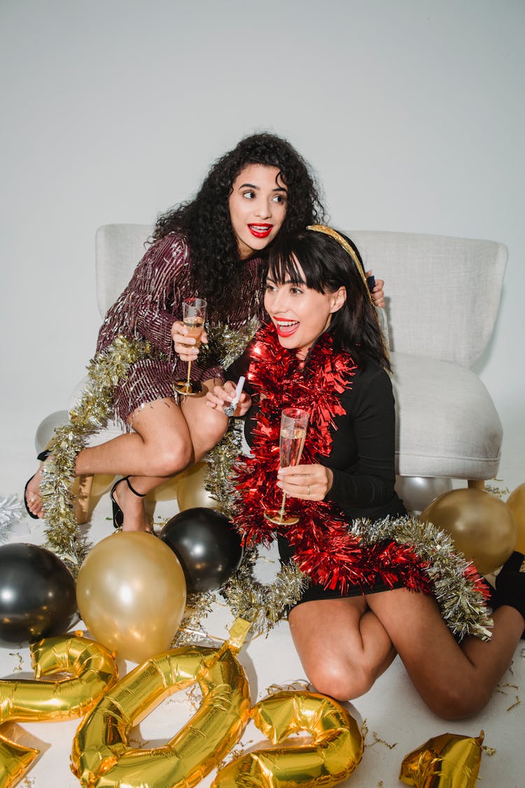 Young Cheerful Women Entertaining At New Year Party