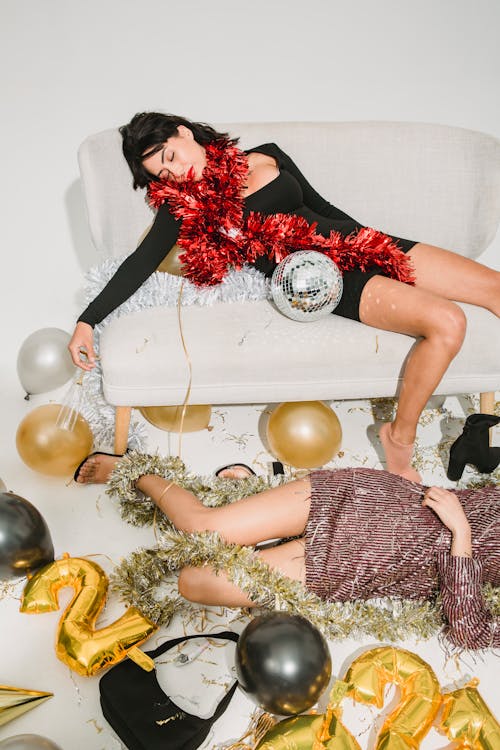 Free Drunk women relaxing among New Year decorations Stock Photo