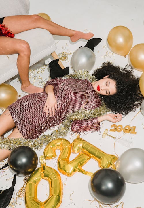 Drunk women sleeping among balloons after New Year party