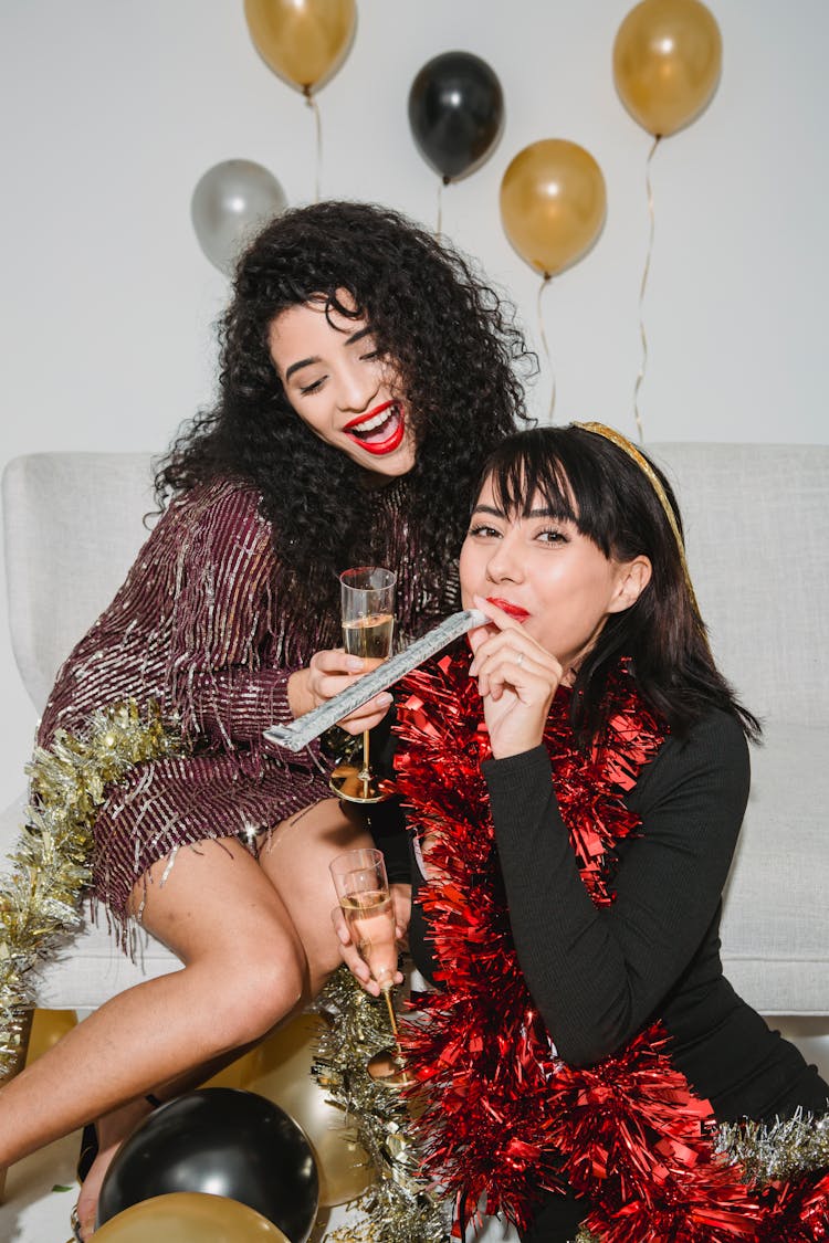 Cheerful Glamour Women With Party Whistle And Glasses Of Champagne