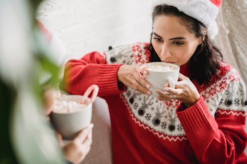 A Woman in Red Sweater Holding White Ceramic Cup