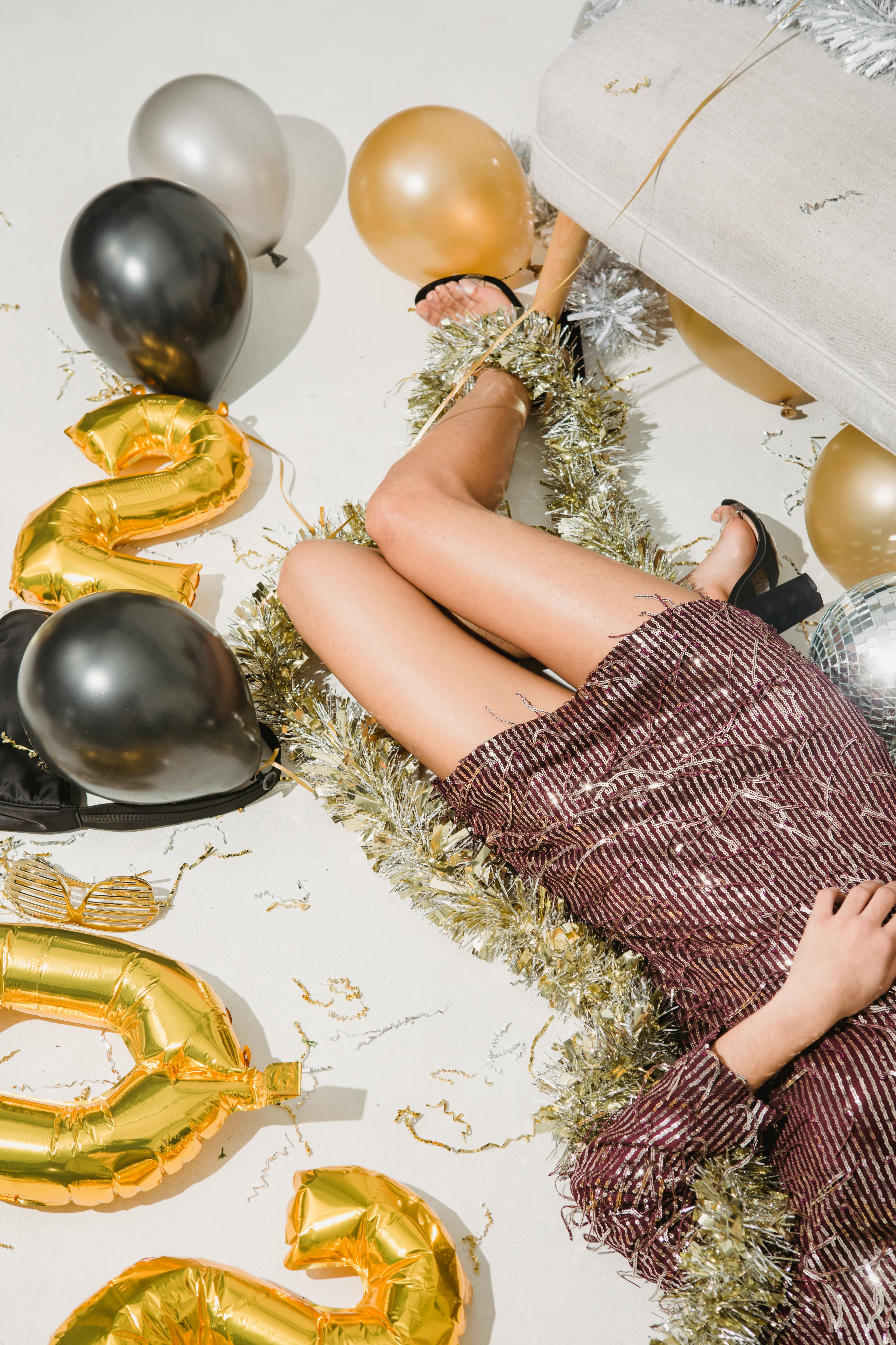 female in festive clothes lying on floor with christmas decorations