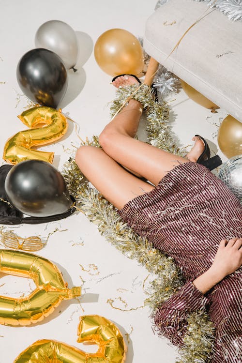 Free Female in festive clothes lying on floor with Christmas decorations Stock Photo