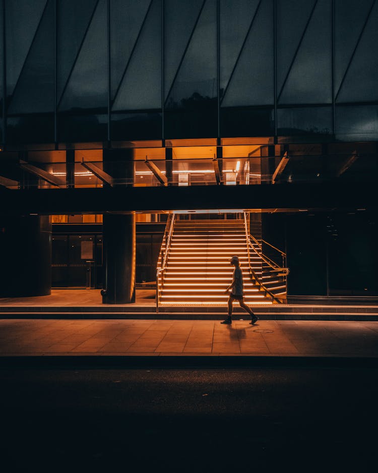 Person Walking By Modern Building