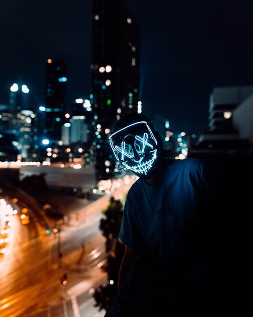 Man Wearing Neon Mask at Night