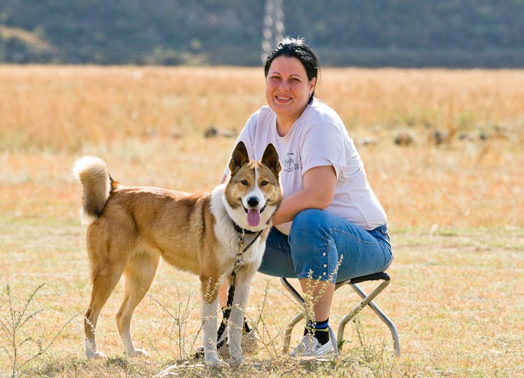 A Woman Sitting With Her Dog