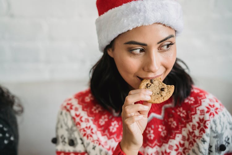 Lady Eating Biscuit In Christmas At Home